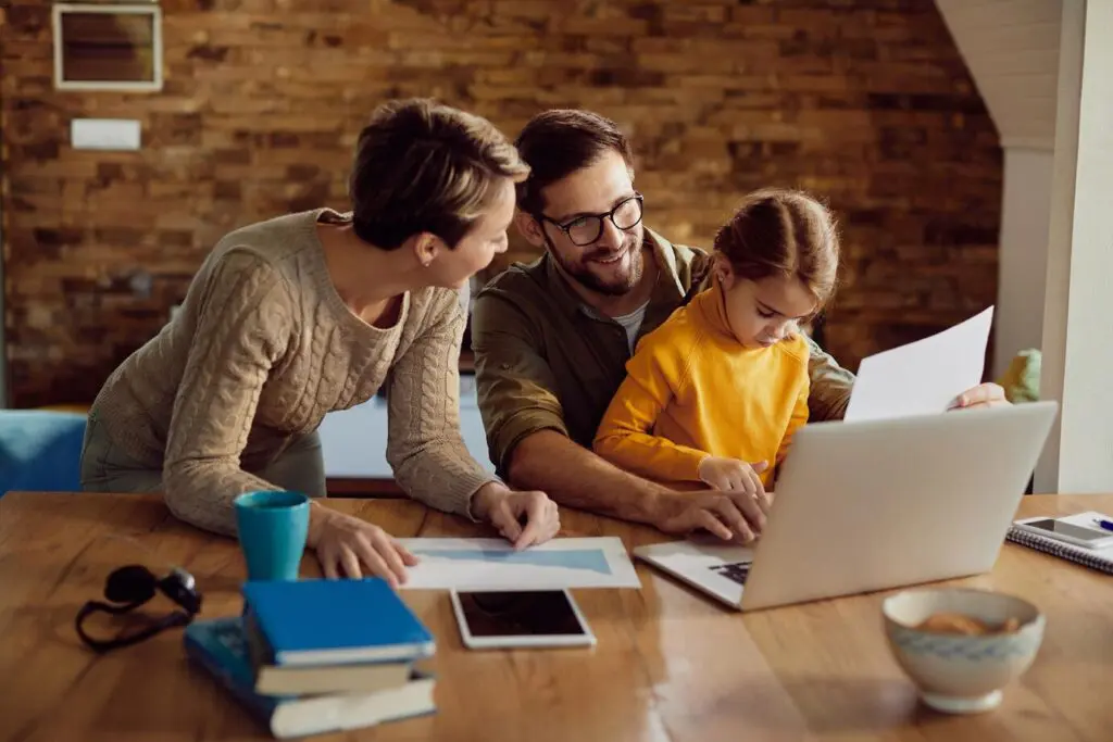 happy-working-father-using-laptop-with-his-family-home_637285-12172